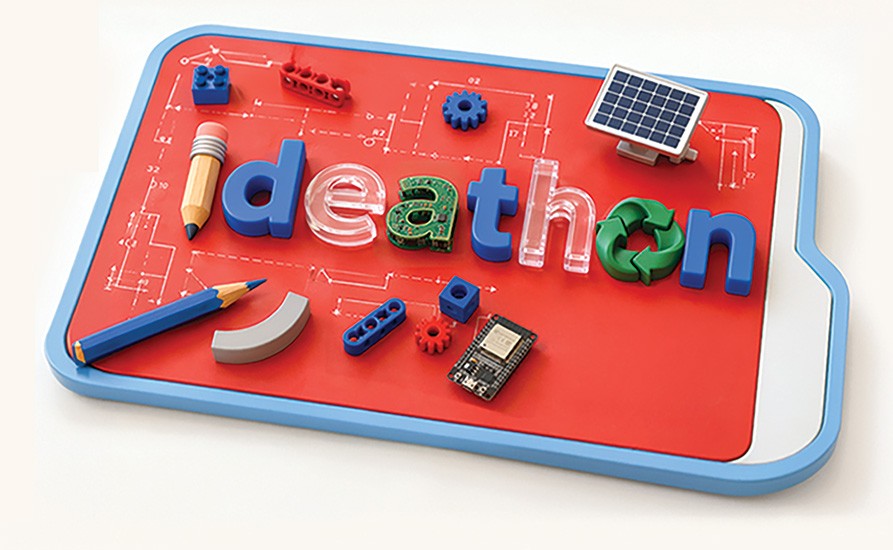 Üzerinde kalem, güneş paneli, dişli ve geri dönüşüm simgeleriyle “ideathon” yazan tasarım panosu